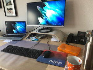 Schreibtisch mit Monitor, Laptop, Tastatur und Maus